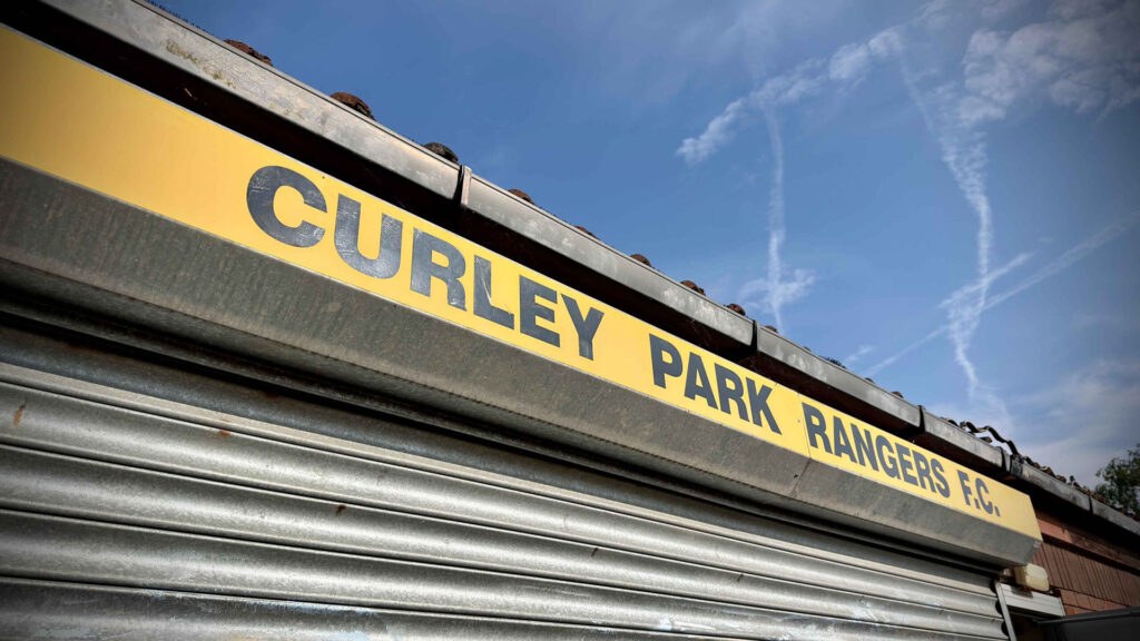 Curley Park Rangers FC name on yellow and grey club shutters